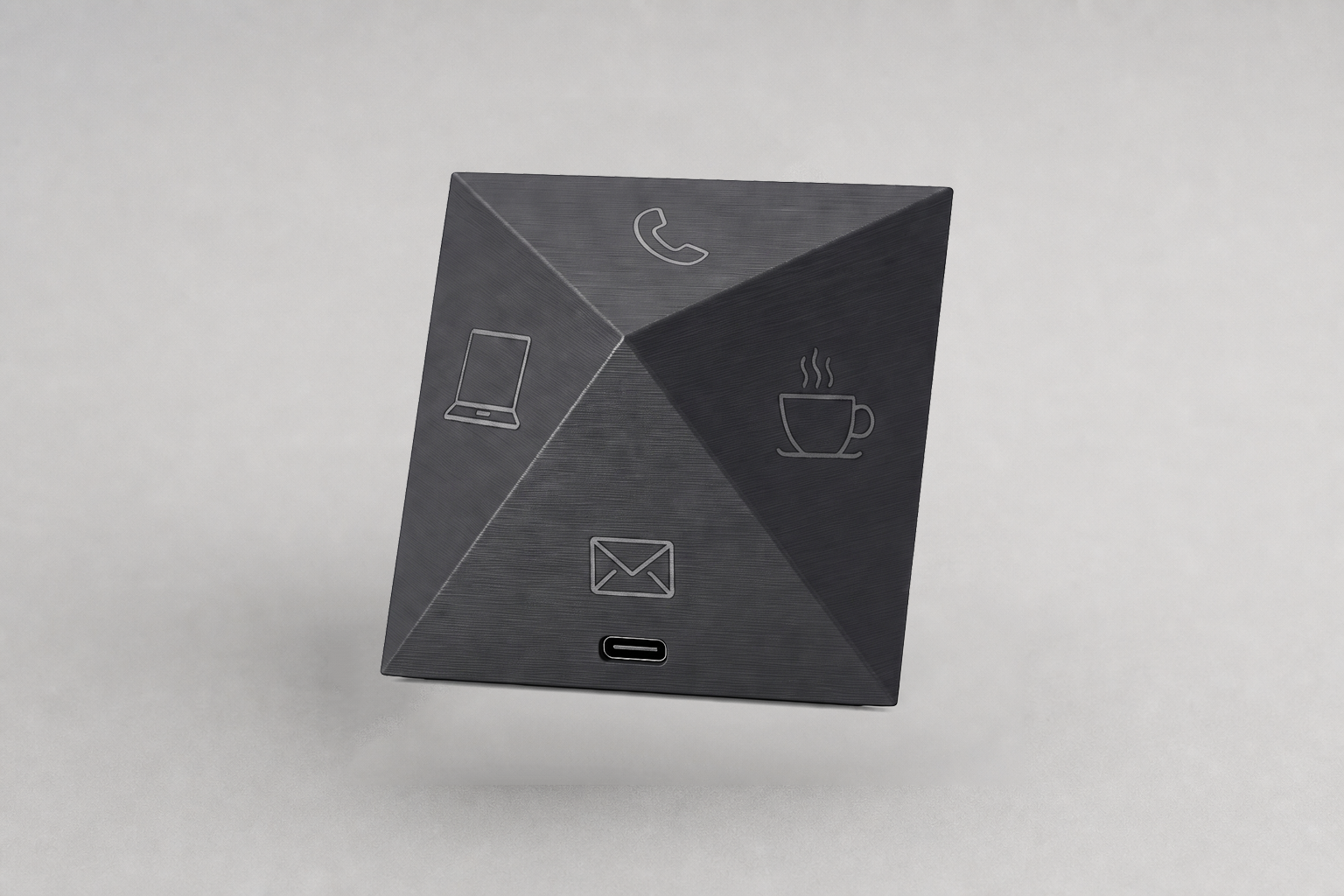 TaskMate charcoal octahedron time-tracking cube on a studio surface